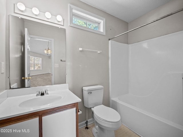 full bathroom featuring washtub / shower combination, vanity, toilet, and a wealth of natural light