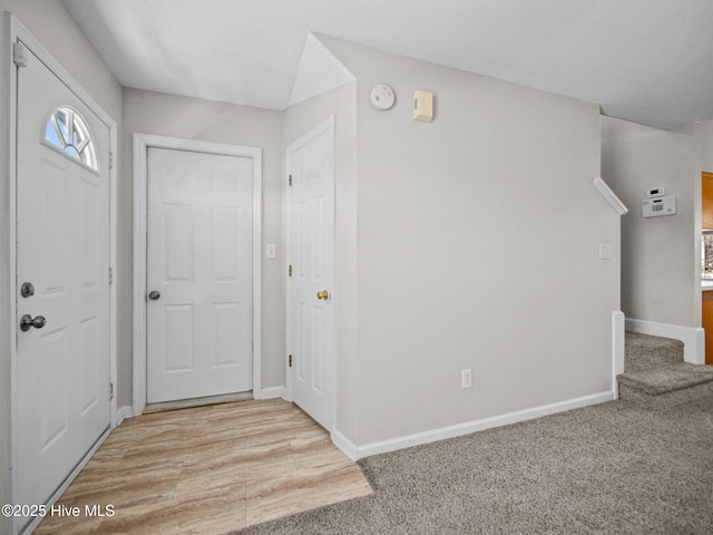 foyer entrance with light colored carpet