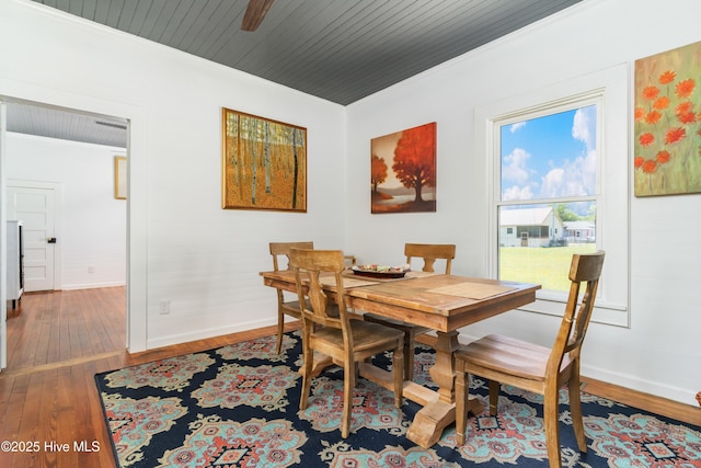 dining space with hardwood / wood-style flooring, crown molding, and wooden ceiling