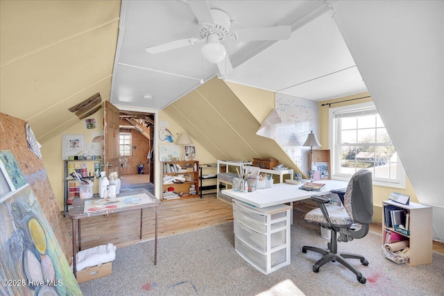 home office featuring a ceiling fan, vaulted ceiling, and wood finished floors