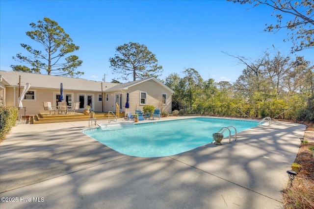 view of pool with a fenced in pool, a patio area, fence, and a wooden deck