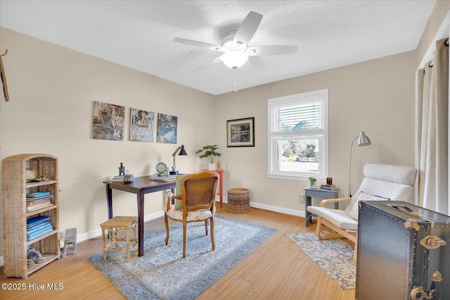 office featuring a textured ceiling, wood finished floors, and baseboards