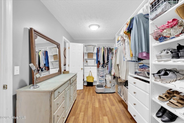 walk in closet featuring light wood-style floors