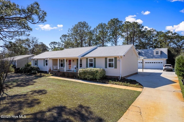 ranch-style home with covered porch, an outdoor structure, a detached garage, and a front lawn