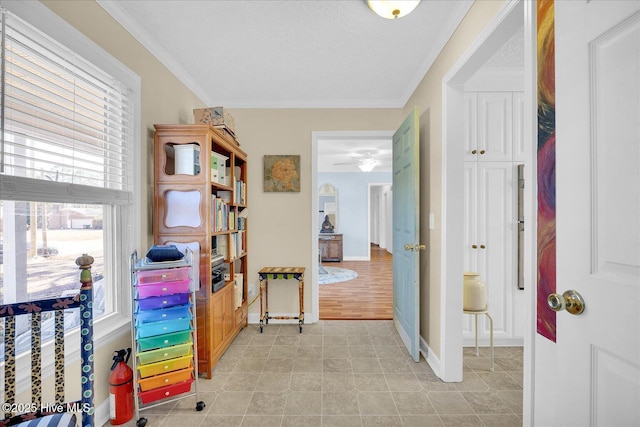 hallway featuring crown molding and baseboards