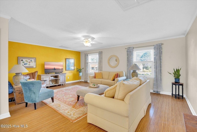 living area featuring ornamental molding, wood finished floors, and a wealth of natural light