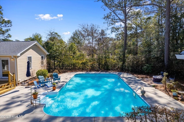 outdoor pool with a patio area