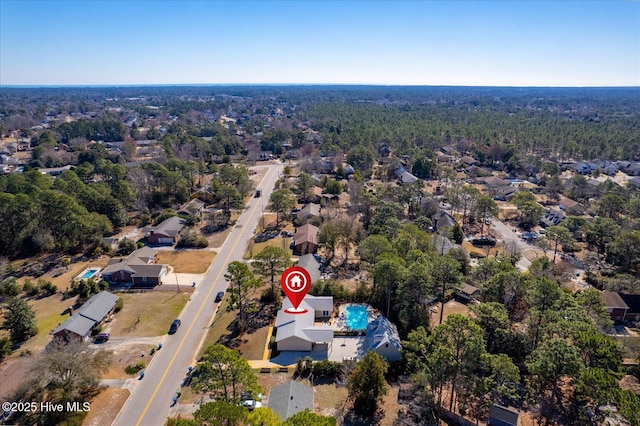 birds eye view of property with a view of trees