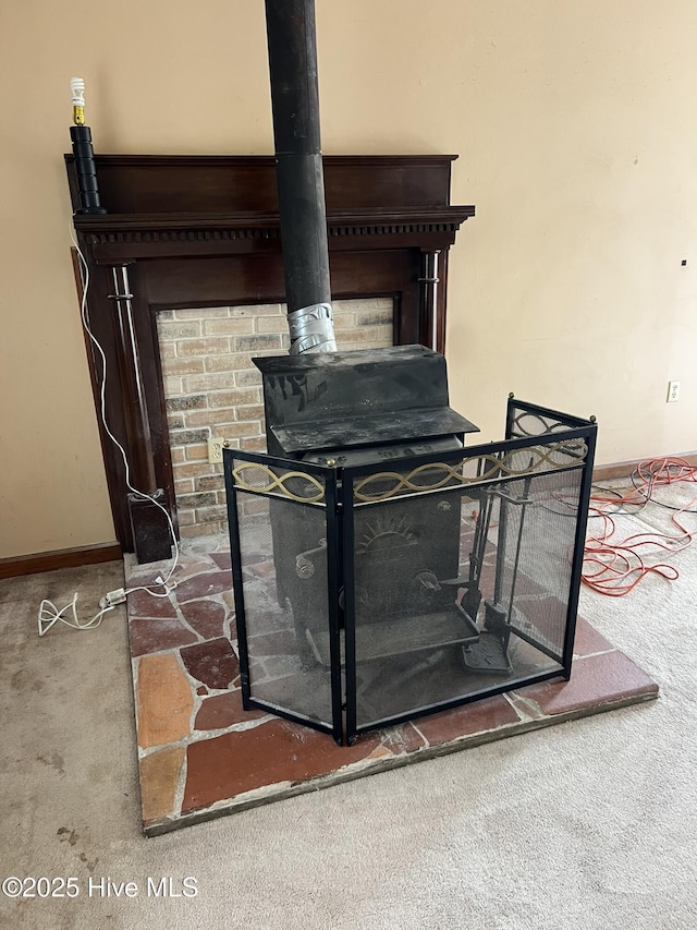 details featuring carpet floors, a wood stove, and baseboards