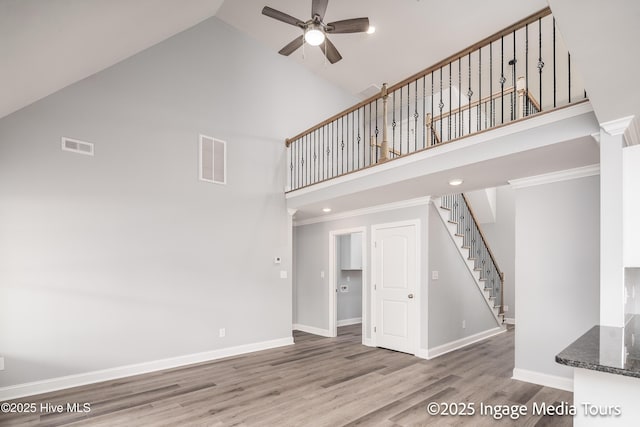 1200 Hunley Ct, Winterville, NC 28590 - unfurnished living room with visible vents, ceiling fan, stairway, wood finished floors, and high vaulted ceiling