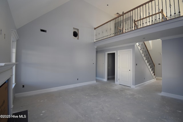 unfurnished living room featuring concrete flooring and high vaulted ceiling