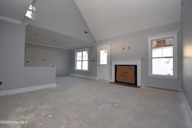 unfurnished living room with ornamental molding and high vaulted ceiling