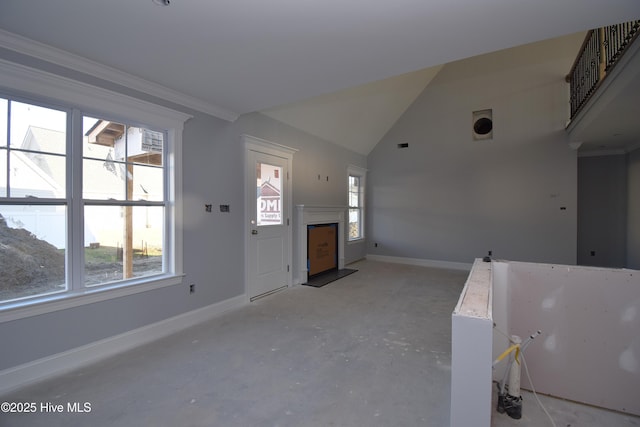 entrance foyer with ornamental molding and high vaulted ceiling