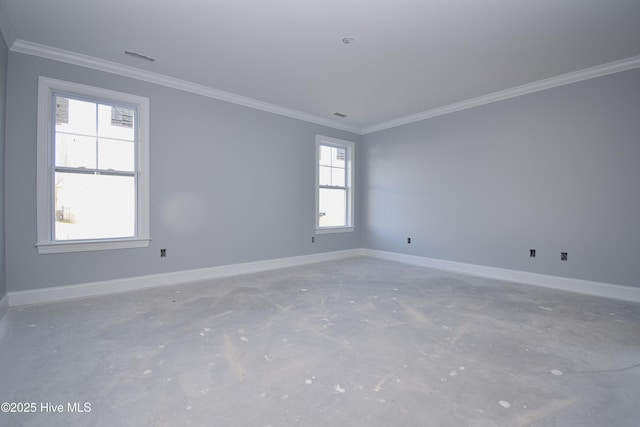 empty room featuring ornamental molding and concrete floors