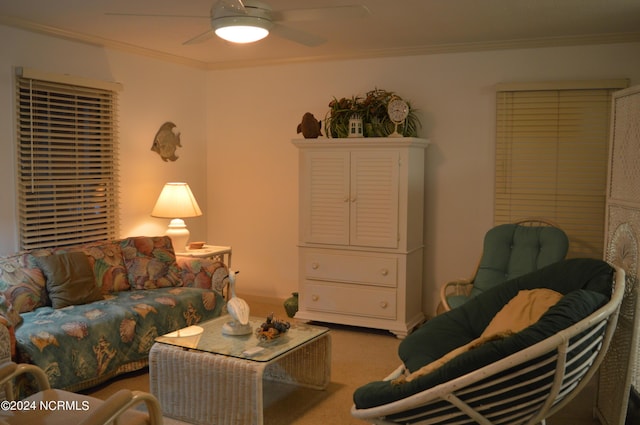 living room featuring ceiling fan, ornamental molding, and carpet floors