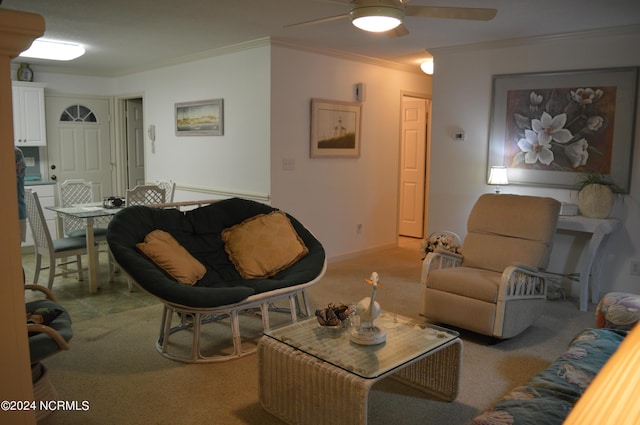 carpeted living room featuring ornamental molding and ceiling fan