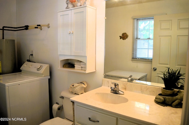 bathroom with washer / clothes dryer, vanity, toilet, and water heater