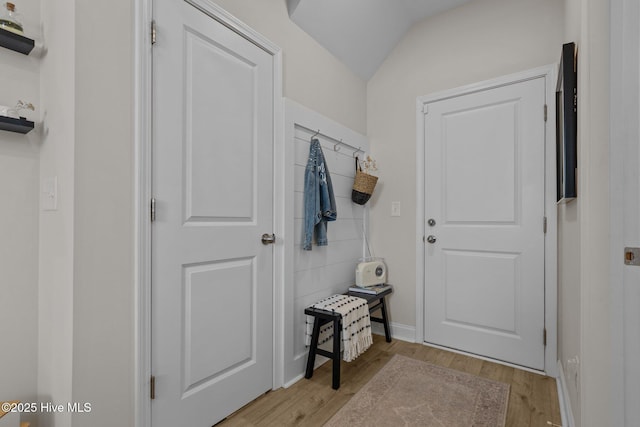 mudroom featuring light wood-type flooring and lofted ceiling