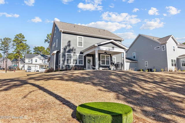 rear view of property featuring ceiling fan