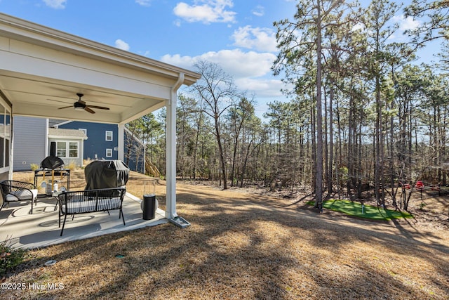 view of yard featuring ceiling fan and a patio area