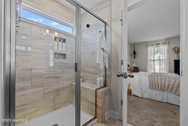 bathroom featuring a shower with door