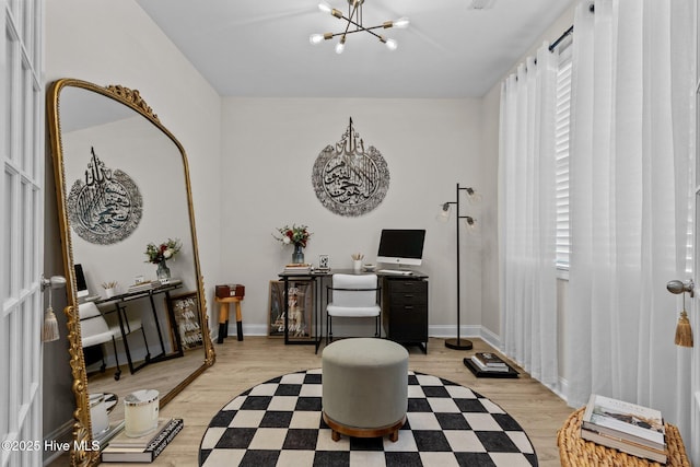 office featuring light hardwood / wood-style floors and a notable chandelier