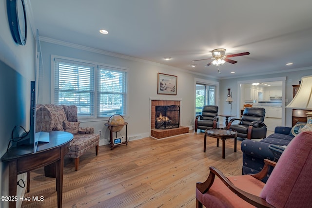 living room featuring visible vents, a brick fireplace, crown molding, light wood-type flooring, and recessed lighting