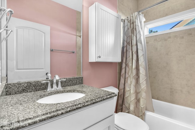 full bathroom with toilet, vanity, and shower / bath combination with curtain