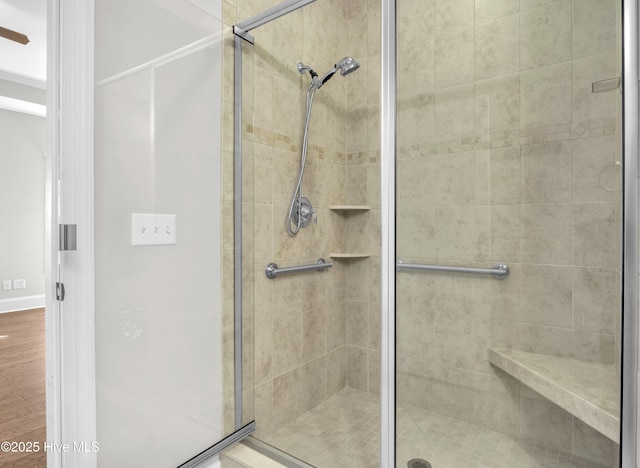 bathroom featuring wood-type flooring and a shower with shower door