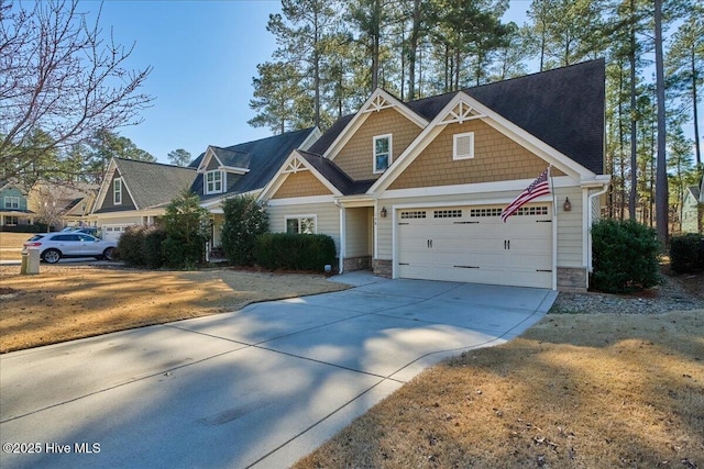 craftsman-style home with stone siding, concrete driveway, and a garage