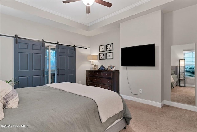 bedroom featuring a barn door, a ceiling fan, baseboards, carpet, and crown molding