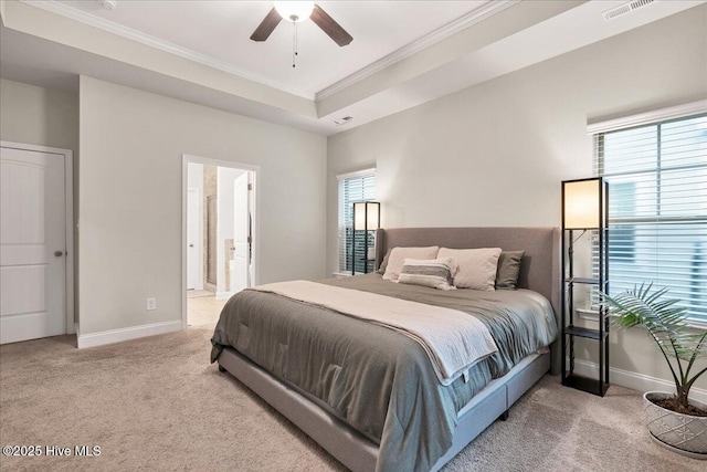 carpeted bedroom with ornamental molding, a raised ceiling, multiple windows, and baseboards