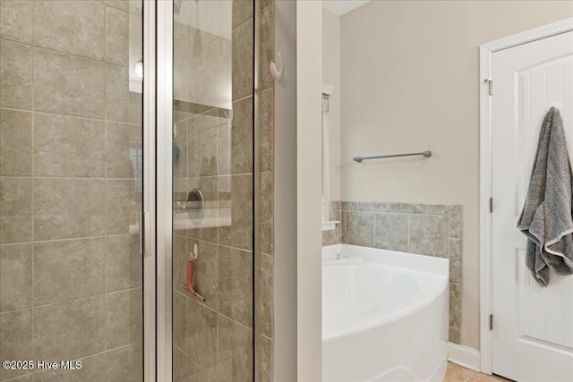 full bathroom featuring a shower stall and a bath