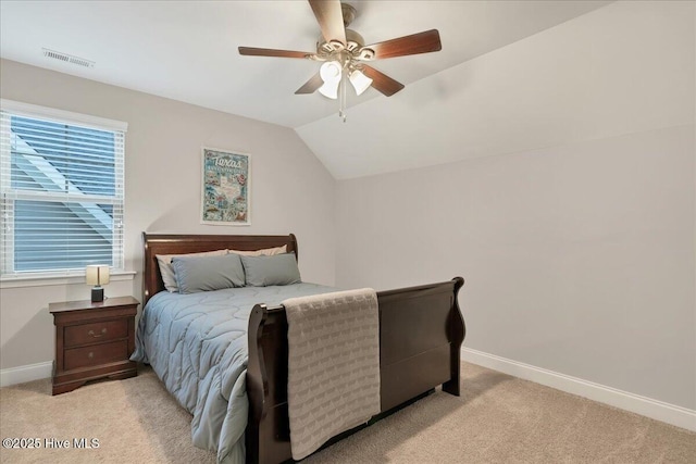 bedroom with light colored carpet, visible vents, lofted ceiling, and baseboards