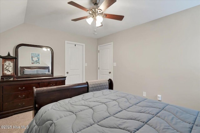 carpeted bedroom featuring lofted ceiling and ceiling fan