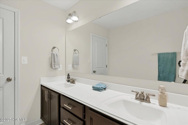 full bathroom featuring double vanity and a sink