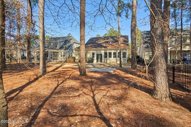 back of house featuring fence