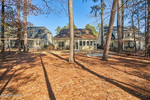 rear view of property with fence