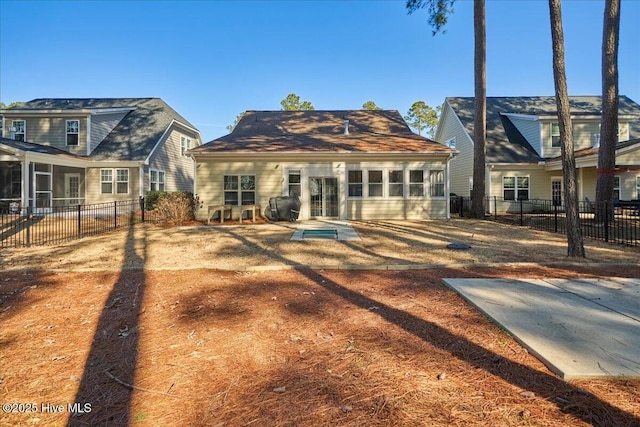 rear view of property featuring fence private yard and a sunroom