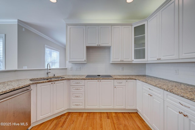 kitchen with crown molding, light wood-style flooring, decorative backsplash, stainless steel dishwasher, and a sink