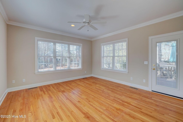 unfurnished room with wood finished floors, visible vents, and crown molding