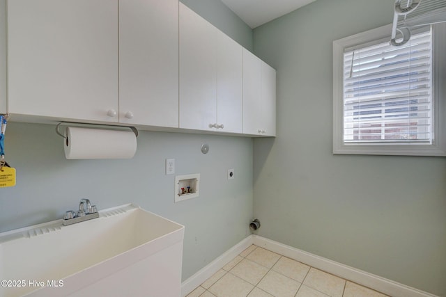 laundry room with hookup for a washing machine, cabinet space, hookup for an electric dryer, a sink, and light tile patterned flooring