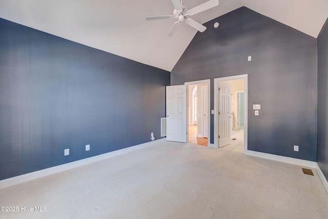 carpeted spare room with high vaulted ceiling, visible vents, ceiling fan, and baseboards