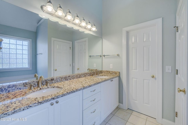 bathroom featuring tile patterned flooring, a sink, and double vanity