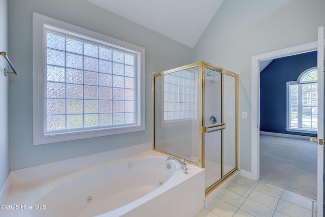 bathroom featuring a stall shower, tile patterned flooring, a jetted tub, and lofted ceiling