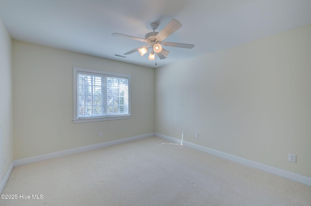 unfurnished room featuring baseboards, visible vents, and carpet flooring