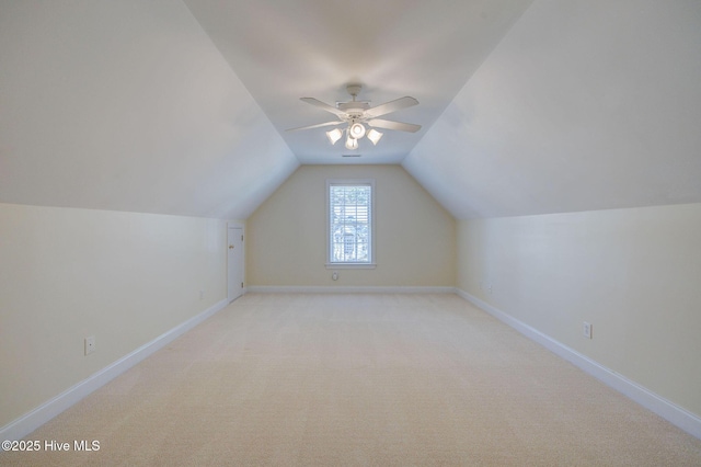 bonus room featuring a ceiling fan, light colored carpet, vaulted ceiling, and baseboards