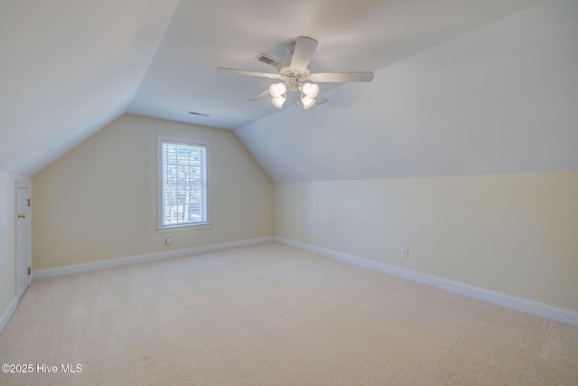 bonus room with visible vents, a ceiling fan, light carpet, vaulted ceiling, and baseboards