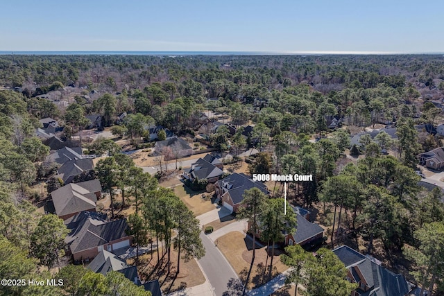 aerial view featuring a residential view and a wooded view