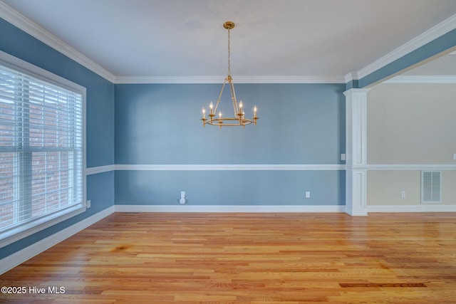 unfurnished dining area with light wood finished floors, visible vents, a notable chandelier, and ornamental molding